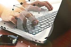 Close up of business man hand working on laptop computer on wood