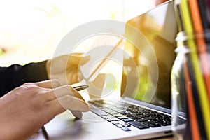 Close up business man hand working on laptop computer on wooden desk as concept, Man hand on laptop keyboard with notebook success