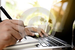 Close up business man hand working on laptop computer on wooden desk as concept, Man hand on laptop keyboard with notebook success