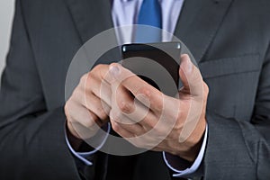 Close up of business man hands holding mobile phone