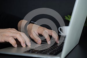 Close up of business man hands typing on laptop computer