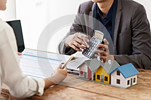 Close up Business man or Real Estate agent explain signing agreement for buying house. Bank manager and real estate