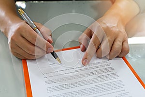 Close up of business man signing contract making a deal.