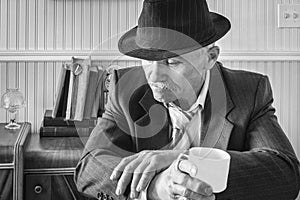 Close up of business man in a suit with cup of coffee.