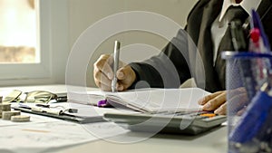 Close-up of a business man taking notes on accounting reports, ideas for costing photo