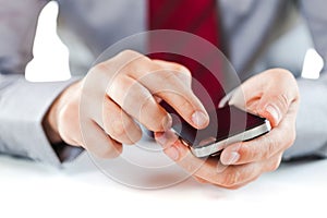 Close up of a business man using a mobile phone