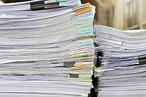 Close up of business papers stack on desk. Pile of unfinished documents on office desk