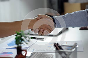 Close-up  of business partners shaking hands and.hand business men and women who shaking hands