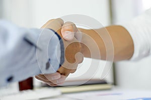 Close-up  of business partners shaking hands and.hand business men and women who shaking hands