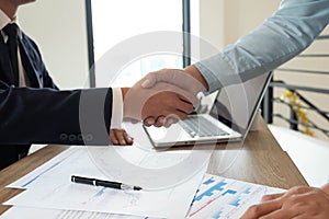 Close-up  of business partners shaking hands and.hand business men and women who shaking hands