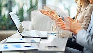 Close-up of business people clapping hands.