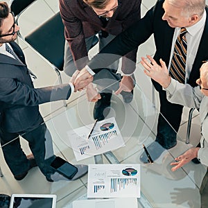 Close up. business people confirming a financial agreement with a handshake .