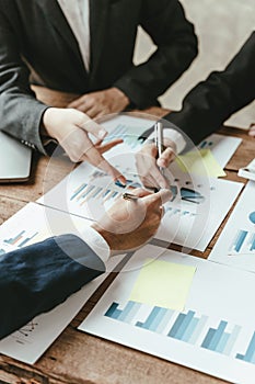 Close-up of business people hands with pen explaining a financial plan