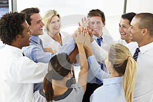 Close Up Of Business People Joining Hands In Team Building Exercise photo