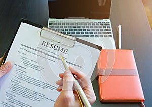 Close-up Business people reading resumes to recruit people for work