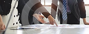 Close up business people team meeting in conference room in company. Businessman pointing pen at document on the table