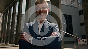 Close up business portrait outdoors in city middle-aged Caucasian man businessman toothy smiling at camera office