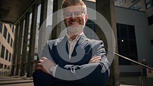 Close up business portrait outdoors in city middle-aged Caucasian man businessman toothy smiling at camera office