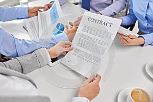 Close up of business team with charts and contract
