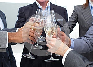 Close-up of business team toasting with Champagne