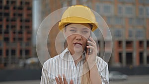 Close-up, business woman architect talking on the phone. lady in a hard hat 4K