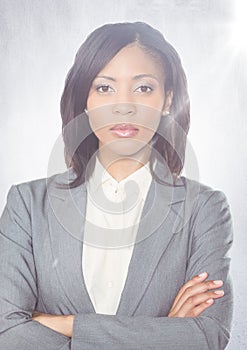 Close up of business woman arms folded with flare against white wall