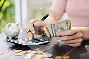 Close up of business woman with calculator counting money. saving money and financial concept