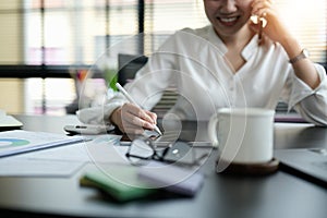 Close up business woman hand holding stylus pen and digital tablet for planning working schedule in office