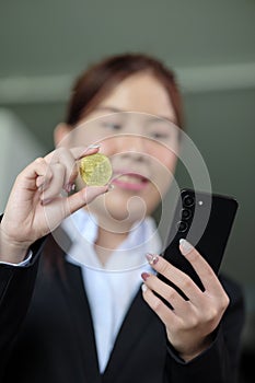 Close Up Business woman look at Bitcoin btc cryptocurrency in finance exchange trade for digital money gold technology