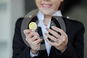 Close Up Business woman look at Bitcoin btc cryptocurrency in finance exchange trade for digital money gold technology