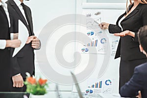 Close up. business woman making a presentation to his business team