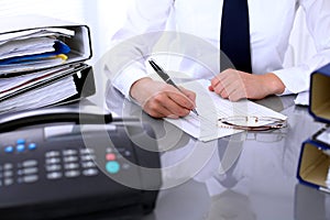 Close up of business woman making report, calculating or checking balance.