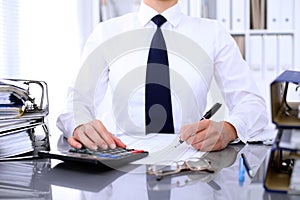 Close up of business woman making report, calculating or checking balance.