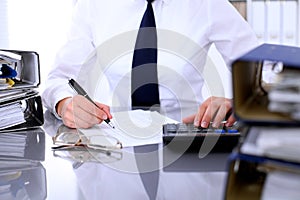 Close up of business woman making report, calculating or checking balance.