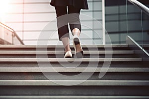 Close-Up of Business Woman\'s Feet Climbing Stairs to Achieve Goals. created with Generative AI