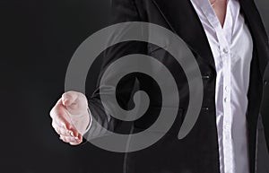 Close up.business woman stretches out her hand for handshake.isolated on black background