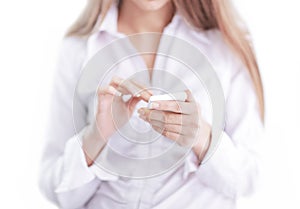 Close up.business woman is typing SMS on mobile phone