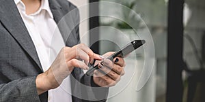 Close up of business woman using mobile smart phone