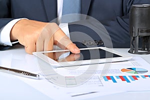 Close-up Of Businessman Analyzing Graph On Digital Tablet