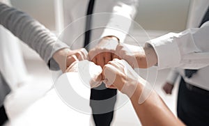 Close up .businessman and businesswoman making a fist bump on building background