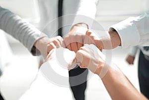 Close up .businessman and businesswoman making a fist bump on building background