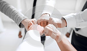 Close up .businessman and businesswoman making a fist bump on building background