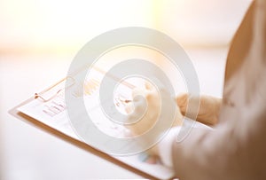 Close up.businessman checking sales schedule.photo on blurred background