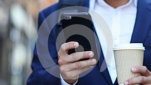 Close Up Of Businessman On City Street Text Messaging