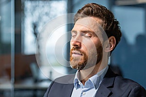 Close up businessman with closed eyes dreaming and breathing fresh clean air, mature boss in business suit thinking