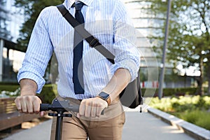 Close Up Of Businessman Commuting To Work On Scooter