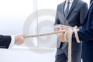 Close up.businessman drags his business team by the rope
