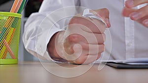 Close-up businessman gets stress at work nervous breakdown. A man shows aggression at work and hits his desk with his