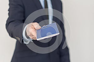 Close-up of a businessman give for inspection his passport.