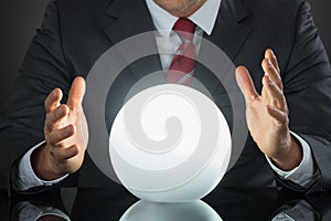 Close-up Of Businessman Hand On Crystal Ball